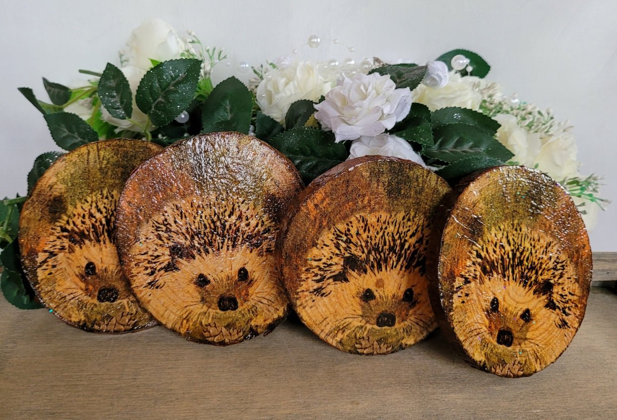 Four Decoupage Natural Wood Slice Hedgehog coasters. Varnished glossy look, hedgehog detail and bark left on the outer edge