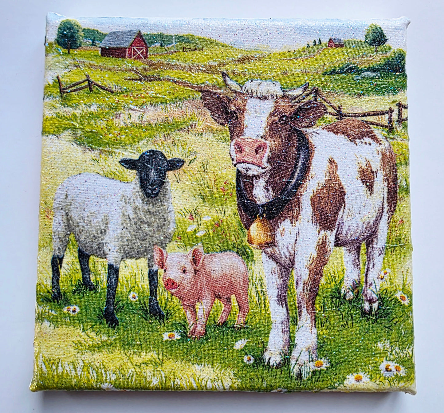colourful farmyard scene picture on stretched white canvas. Decoupage cow, sheep and pig standing in a meadow