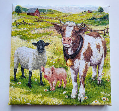 colourful farmyard scene picture on stretched white canvas. Decoupage cow, sheep and pig standing in a meadow