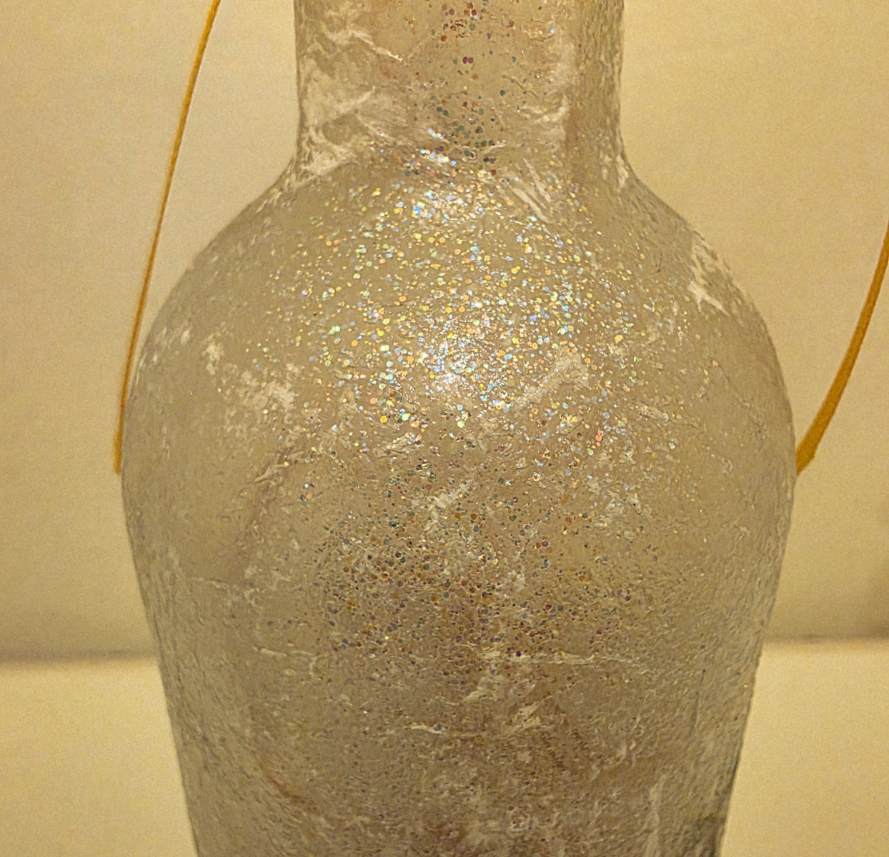 Decorative bottle with textured surface on a neutral background
