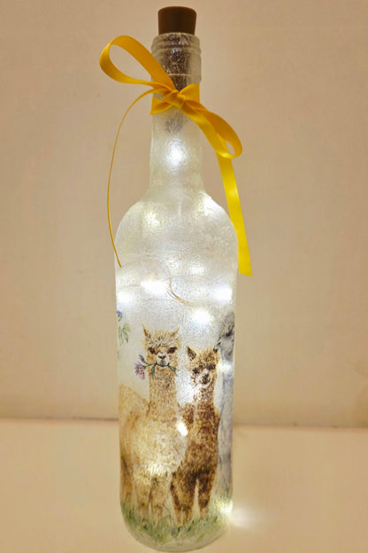 Decorative bottle with LED lights and Alpaca illustration, tied with a yellow ribbon.