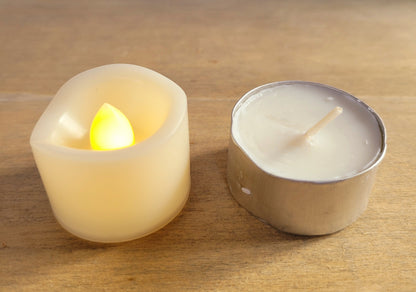 plastic votive candle, switched on, small white tealight candle next door to it