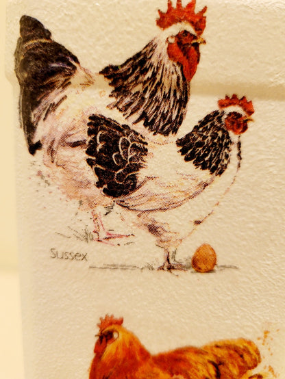 Black and white hen and brown hen on a white painted bottle