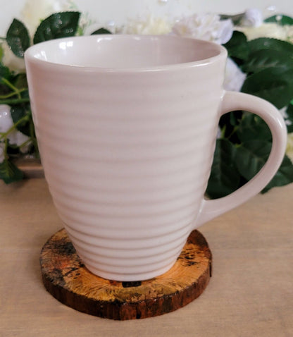 one Decoupage Natural Wood Slice Hedgehog coaster. Varnished glossy look, hedgehog detail and bark left on the outer edge. White mug sitting on top
