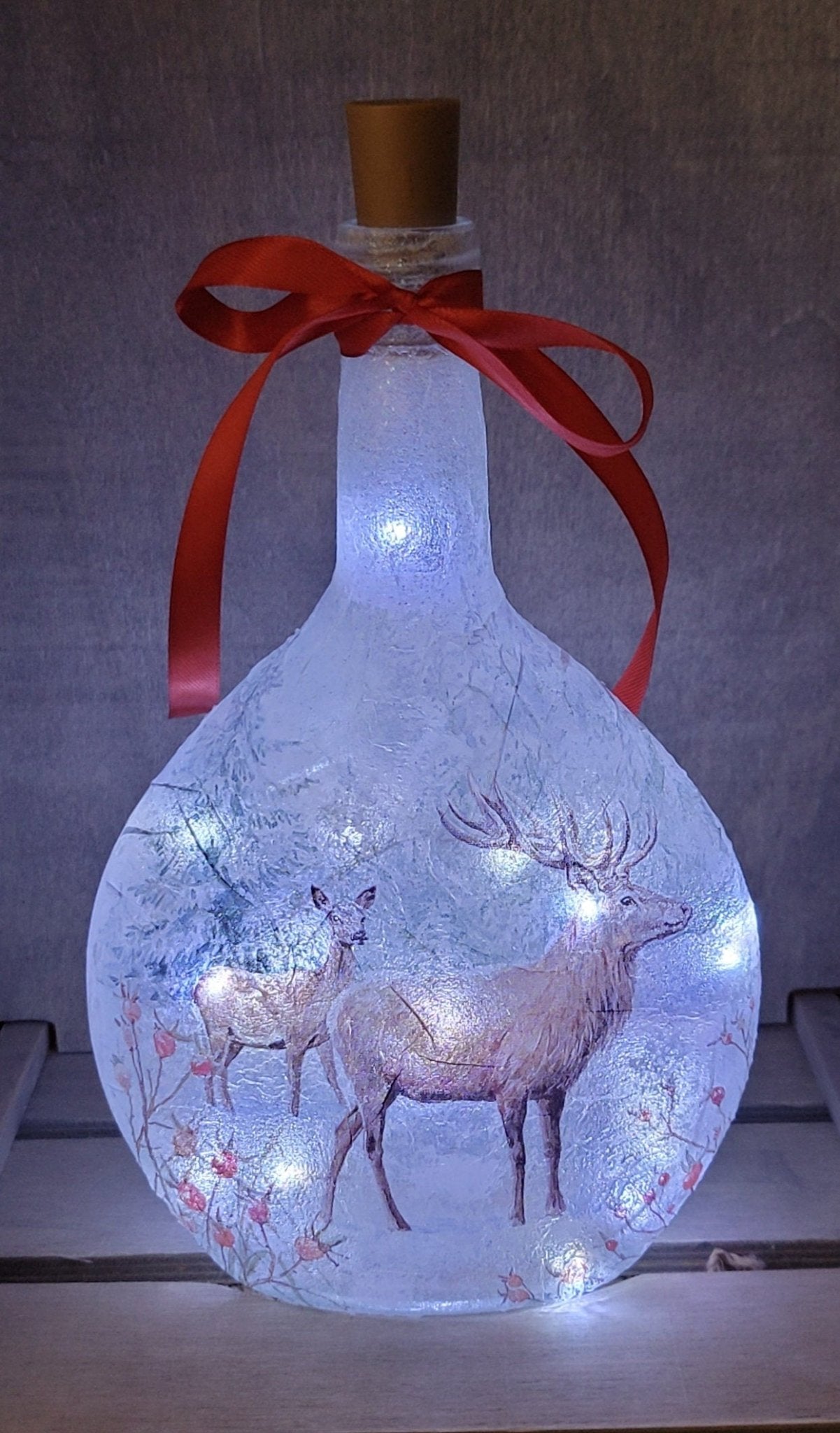 Decoupage Stag Light Up Bottle - Lit up Round glass bottle with Stag detailing. Red bow tied around the neck of the bottle, cork LED lights