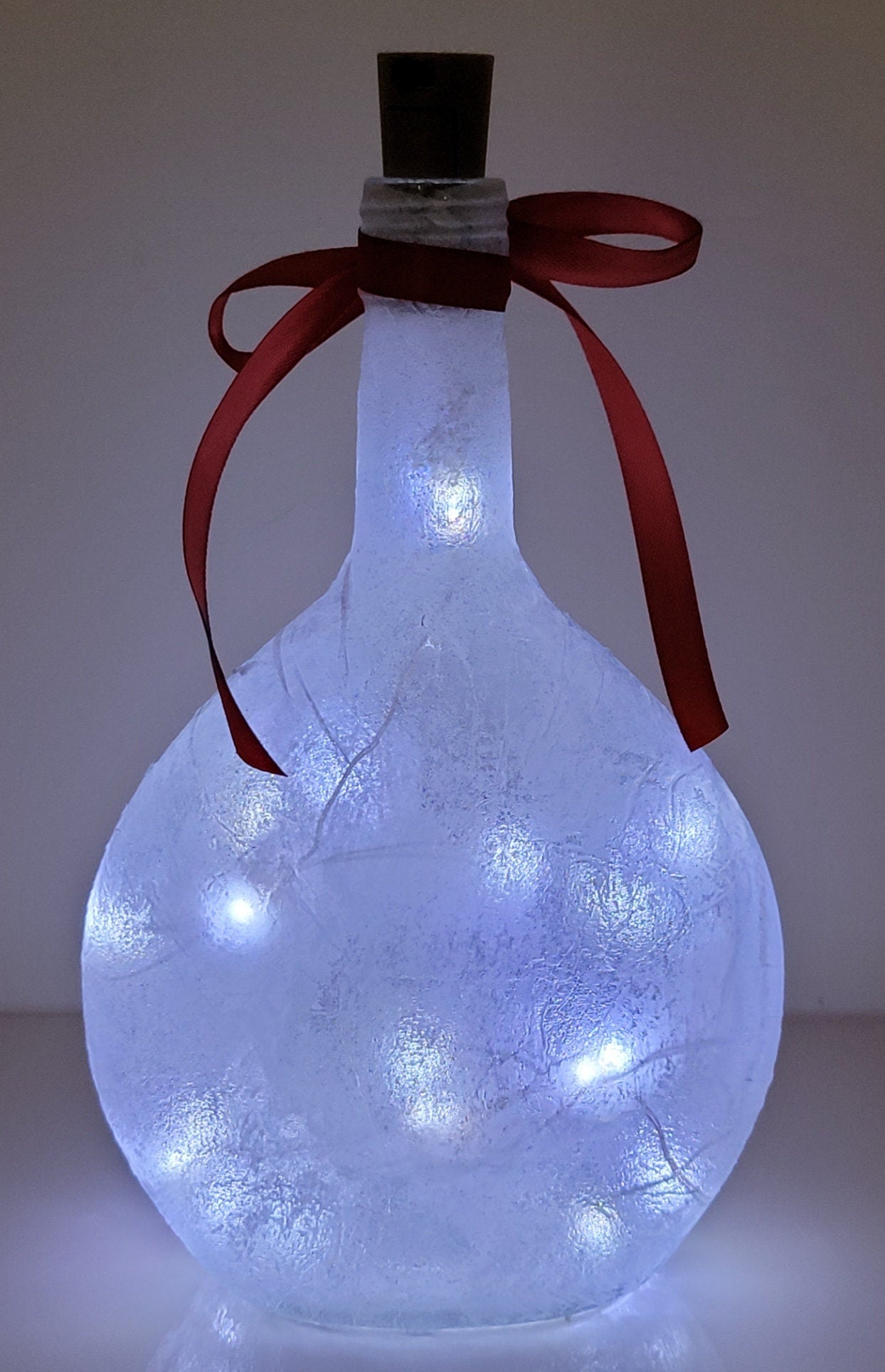 Decoupage Stag Light Up Bottle - Lit up Round glass bottle. Red bow tied around the neck of the bottle, cork LED lights