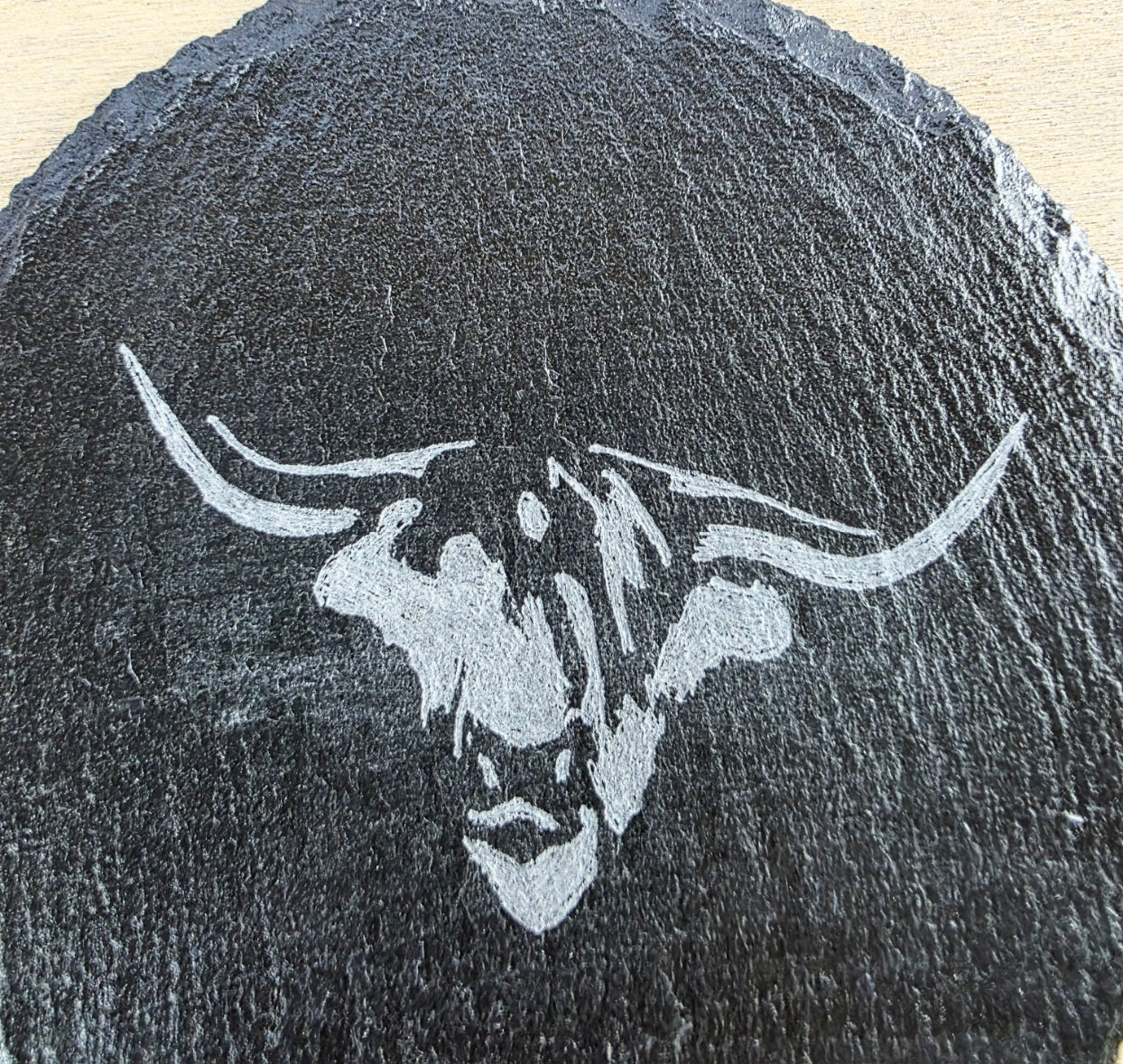 Black slate coaster with white cows head engraving