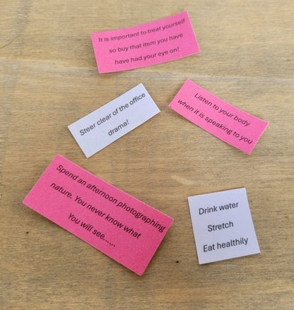 Pink and white pieces of velour paper with inspirational quotes written on them