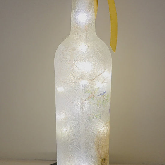 Lit up bottle with Alpacas on. Yellow ribbon embellishment