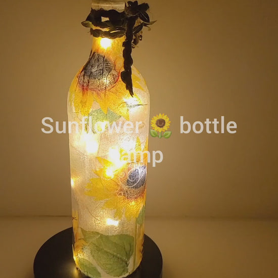 RLit up bottle with sunflower detail. Jute string bow with leavesotating 