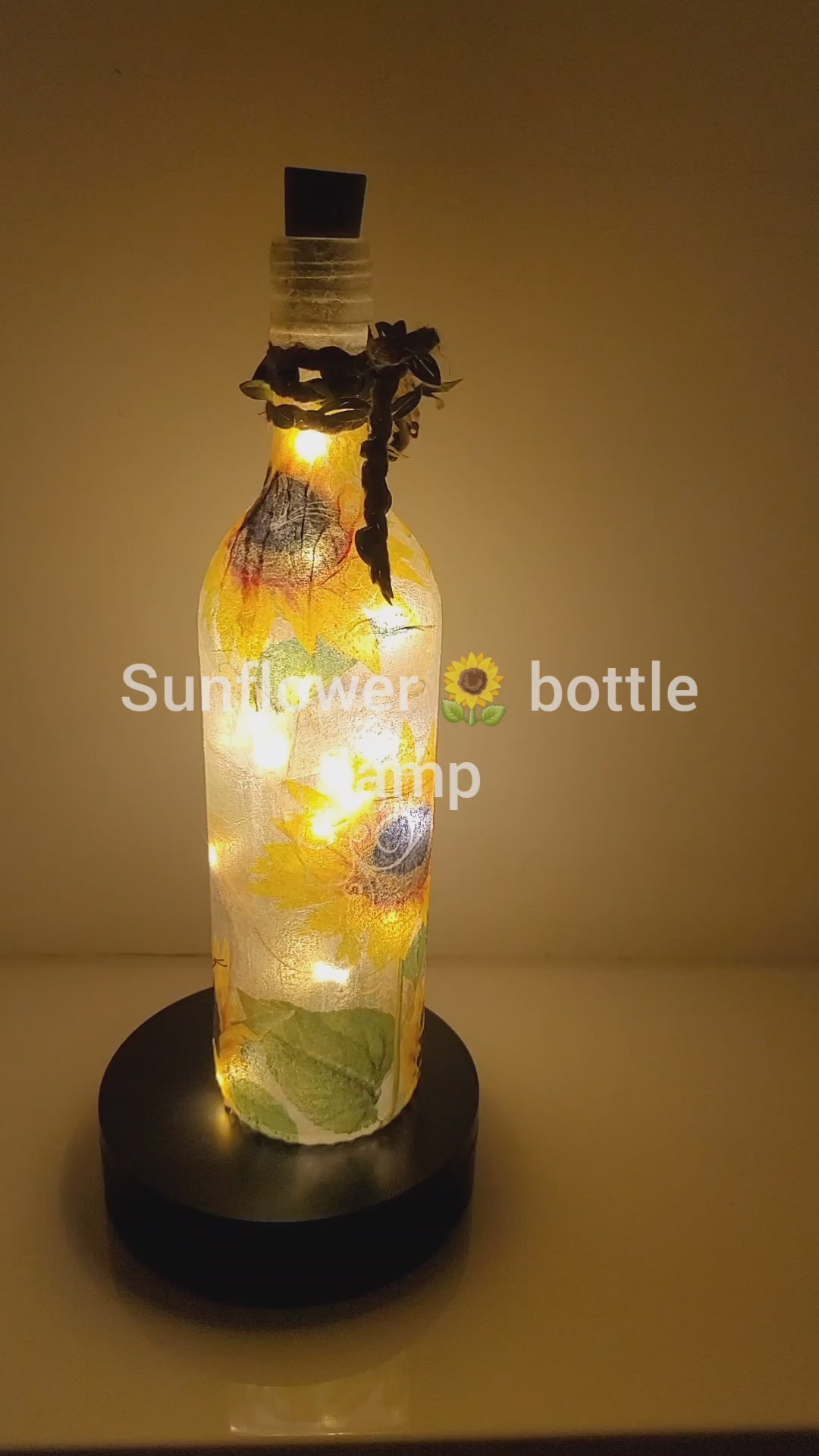 RLit up bottle with sunflower detail. Jute string bow with leavesotating 