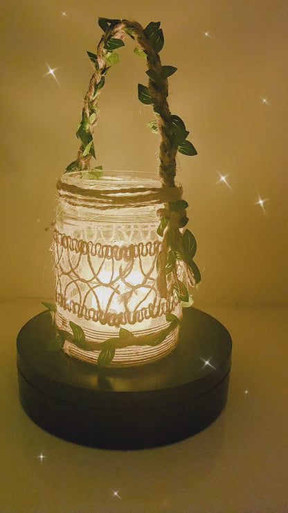 Video of a rotating Decorative lantern with decorative burlap design. Jute handle with leaves glowing light on a table in a cozy living room setting.