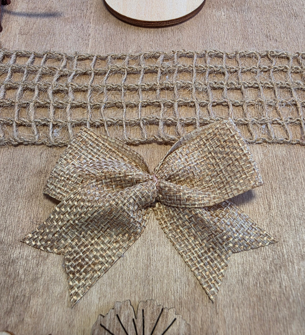 Burlap ribbon with a bow on a wooden surface