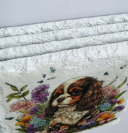 Four white slate coaster edges with a spaniel dog and floral design on a white background