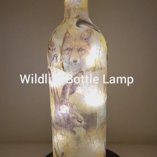 Rotating Lit up wine bottle with wildlife detail. Jute string bow