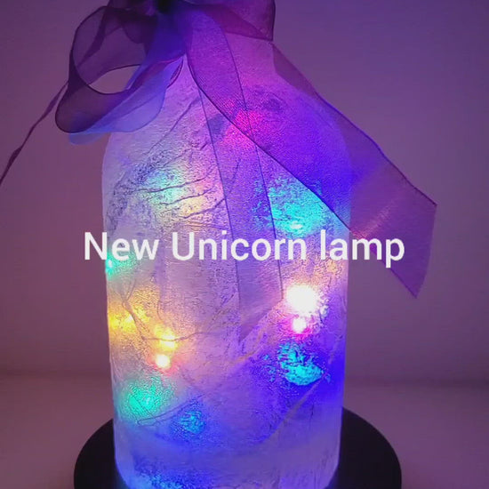 Rotating example of a Lit up Gin bottle with Unicorn detail. Rainbow coloured bow