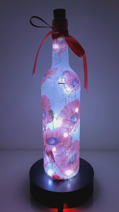 Rotating Lit up wine bottle with Poppy detail. Red Bow